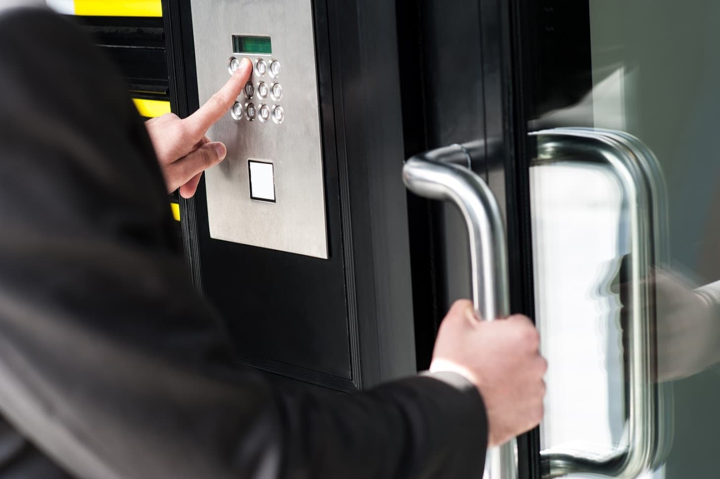 businessman entering safe code to unlock the door.