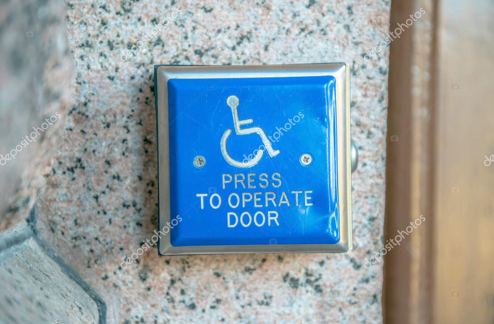 blue handicapped access entrance pad for door mounted to a wall in austin texas