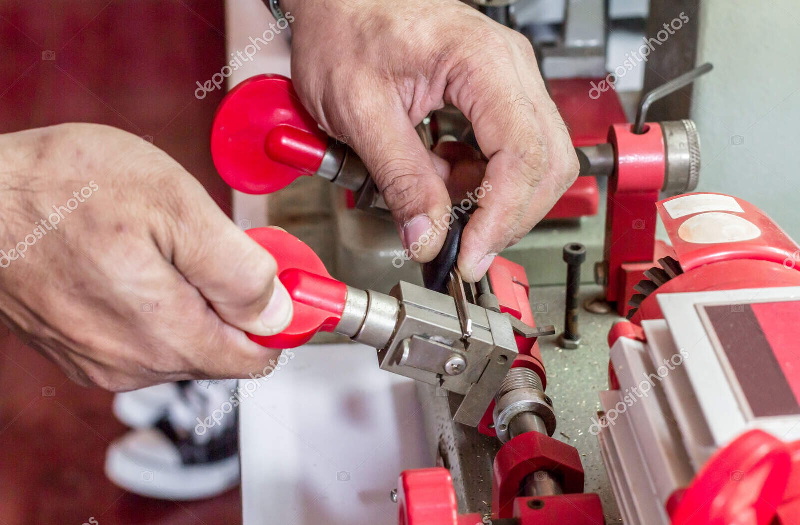 blur locksmith in workshop makes new key. professional making ke